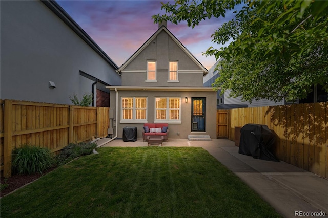 back of house with stucco siding, a patio area, and an outdoor living space
