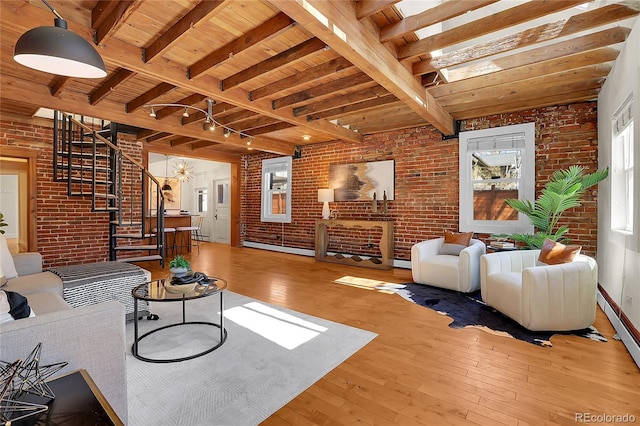 1125 E Kentucky Ave, Denver, CO 80209 - living room featuring brick wall, stairway, hardwood / wood-style flooring, wooden ceiling with exposed beams, and a baseboard radiator