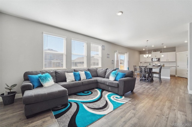 2128 Dexter St, Mead, CO 80542 - living area with wood finished floors, a chandelier, and recessed lighting