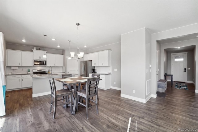 2128 Dexter St, Mead, CO 80542 - dining space with a chandelier, dark wood-type flooring, and recessed lighting