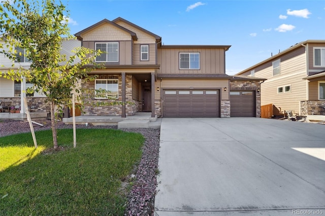 2128 Dexter St, Mead, CO 80542 - craftsman house featuring stone siding, a garage, driveway, and board and batten siding
