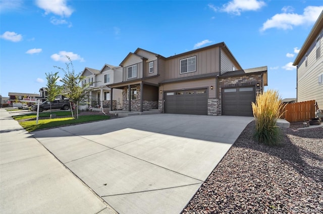 2128 Dexter St, Mead, CO 80542 - view of front facade featuring stone siding, concrete driveway, a garage, board and batten siding, and a residential view