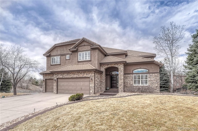 view of front of home featuring a garage, a front yard, concrete driveway, and stucco siding