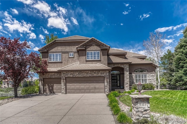 9315 E Aspen Hill Ln, Lone Tree, CO 80124 - view of front of house featuring stone siding, a garage, driveway, stucco siding, and a front yard