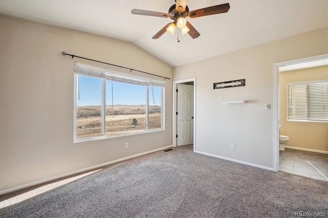 unfurnished bedroom with connected bathroom, baseboards, vaulted ceiling, and carpet flooring