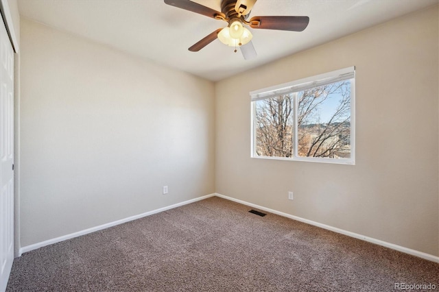 interior space with baseboards, visible vents, and ceiling fan