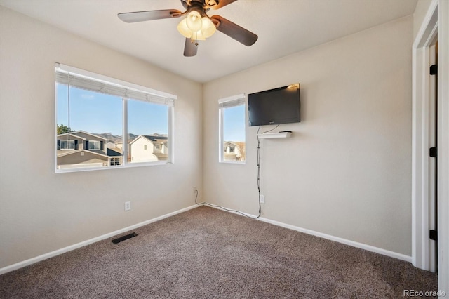 unfurnished bedroom with carpet, visible vents, ceiling fan, and baseboards