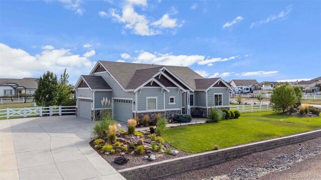 craftsman house featuring a garage and a front lawn