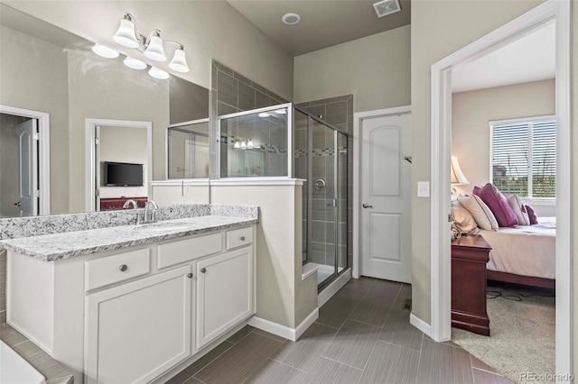 bathroom with vanity, a shower with shower door, and a notable chandelier