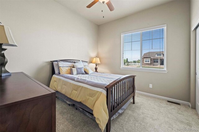 bedroom with light colored carpet and ceiling fan