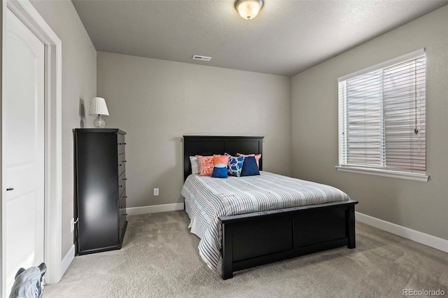 carpeted bedroom featuring a textured ceiling