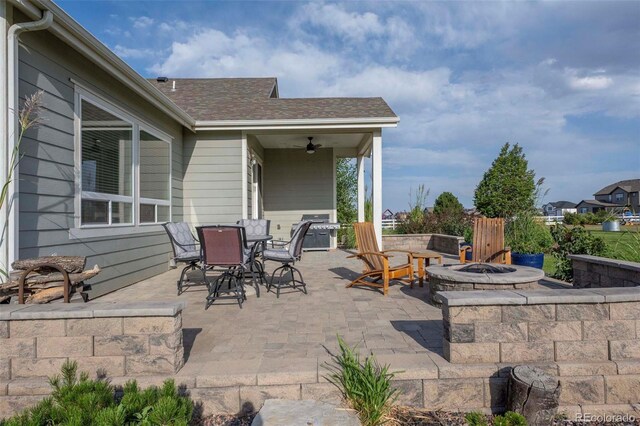 view of patio with a fire pit and ceiling fan