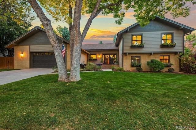 view of front of house with a yard and a garage