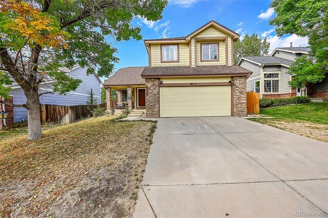 view of front facade with a garage and a front lawn