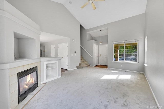 19873 E Vassar Ave, Aurora, CO 80013 - unfurnished living room featuring high vaulted ceiling, carpet, ceiling fan, stairs, and baseboards