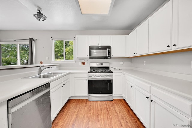 19873 E Vassar Ave, Aurora, CO 80013 - kitchen with stainless steel appliances, a sink, light countertops, and light wood finished floors