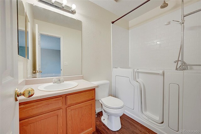 19873 E Vassar Ave, Aurora, CO 80013 - full bath with toilet, a shower, vanity, and wood finished floors