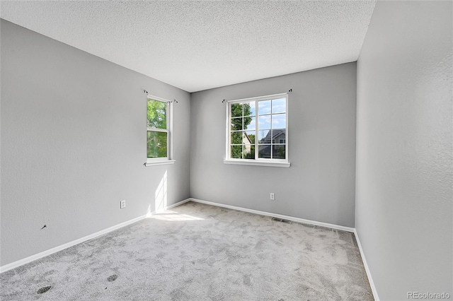19873 E Vassar Ave, Aurora, CO 80013 - unfurnished room with carpet flooring, a textured ceiling, and baseboards