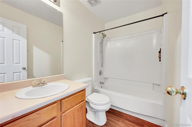 19873 E Vassar Ave, Aurora, CO 80013 - full bath with toilet, vanity, bathtub / shower combination, and wood finished floors
