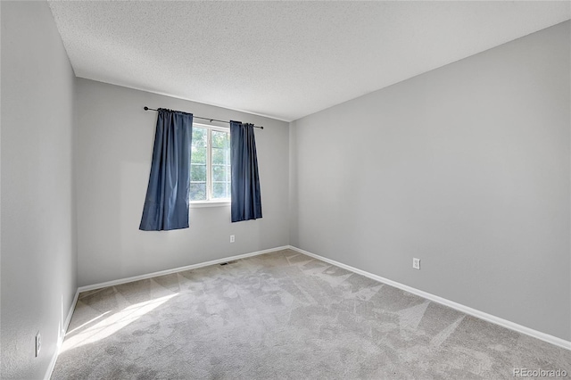 19873 E Vassar Ave, Aurora, CO 80013 - spare room with carpet floors, a textured ceiling, and baseboards
