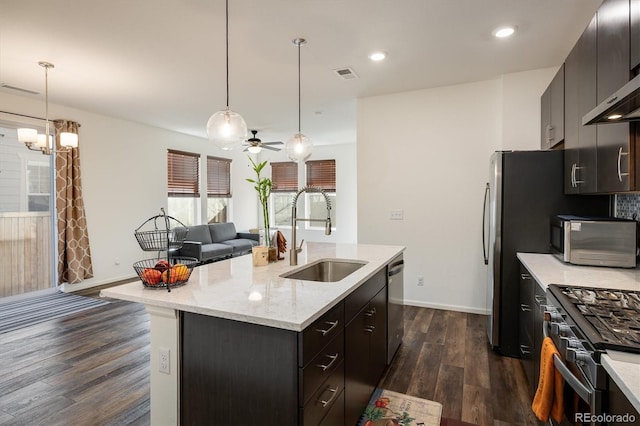 kitchen featuring black range with gas cooktop, a kitchen island with sink, a sink, visible vents, and stainless steel dishwasher