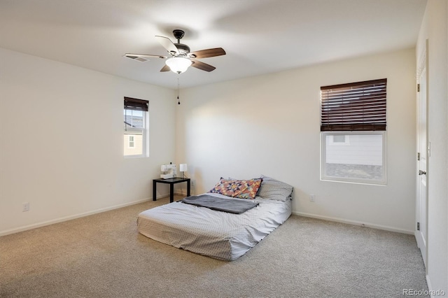 bedroom featuring a ceiling fan, carpet, visible vents, and baseboards