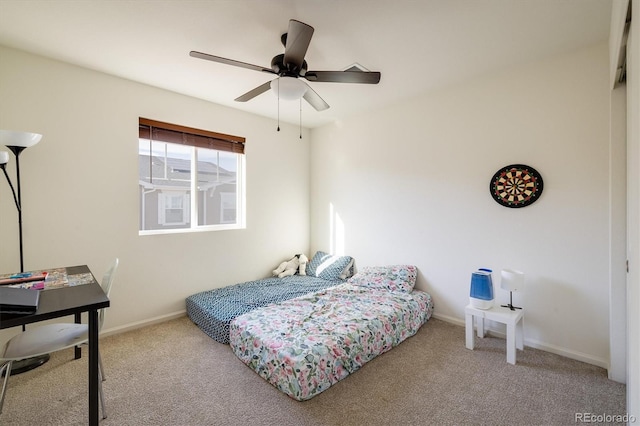 bedroom with ceiling fan, baseboards, and light colored carpet