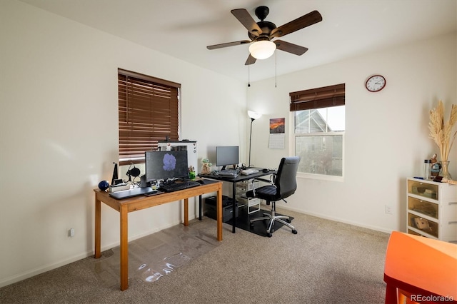 office featuring ceiling fan, baseboards, and light colored carpet