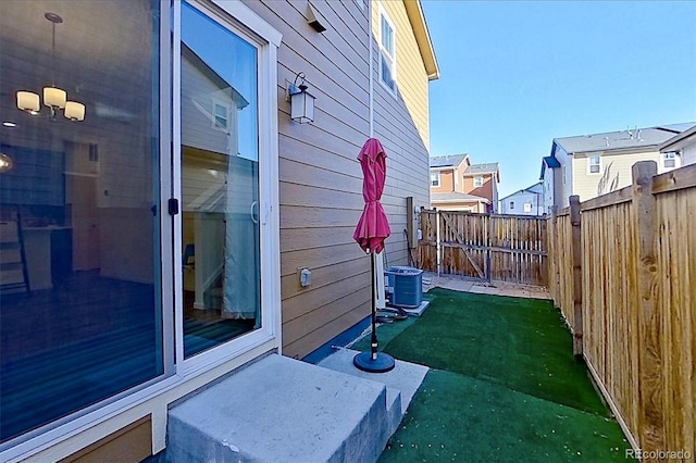 view of yard featuring a residential view, a fenced backyard, and cooling unit