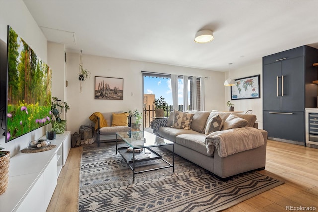 living area featuring light wood-style floors and wine cooler