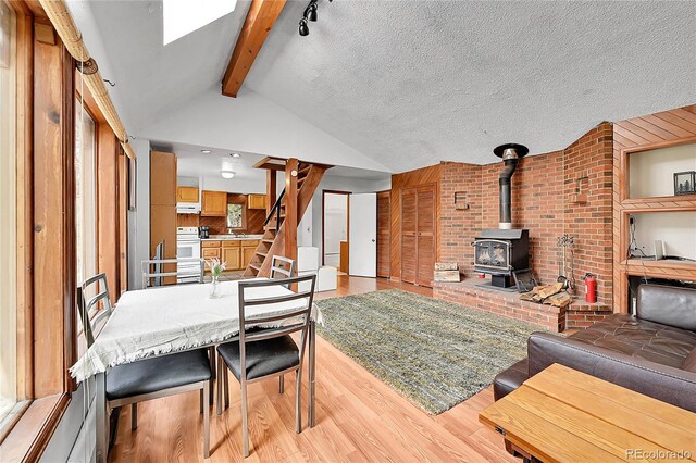 101 Campbell Rd, Bailey, CO 80421 - living room featuring a wood stove, light wood-type flooring, and stairway