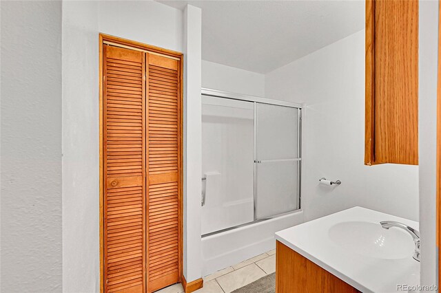 101 Campbell Rd, Bailey, CO 80421 - bathroom featuring a closet, combined bath / shower with glass door, tile patterned floors, and vanity