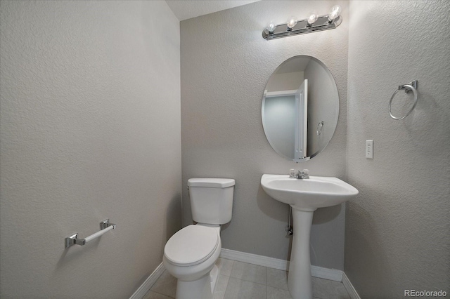 bathroom featuring tile patterned floors, toilet, and sink