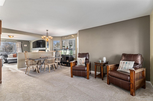 dining area featuring an inviting chandelier and carpet floors