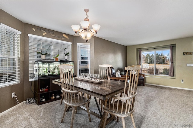 dining area featuring baseboards, carpet, and a chandelier