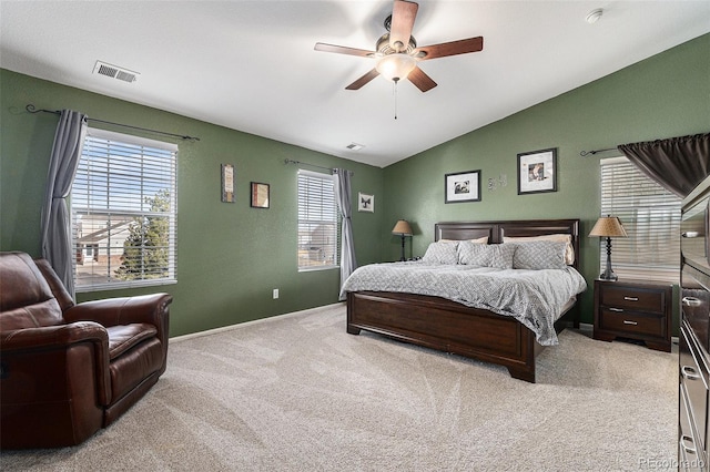 bedroom featuring visible vents, baseboards, ceiling fan, vaulted ceiling, and light carpet