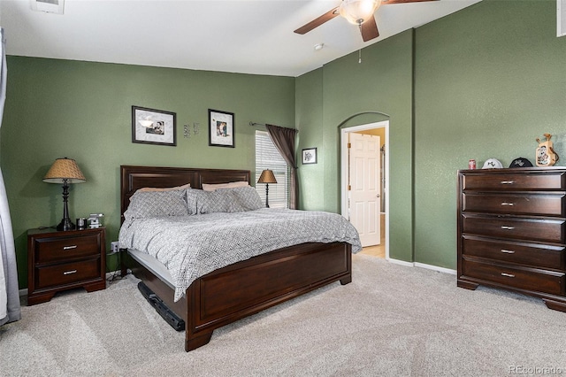 carpeted bedroom featuring lofted ceiling, a ceiling fan, baseboards, and visible vents