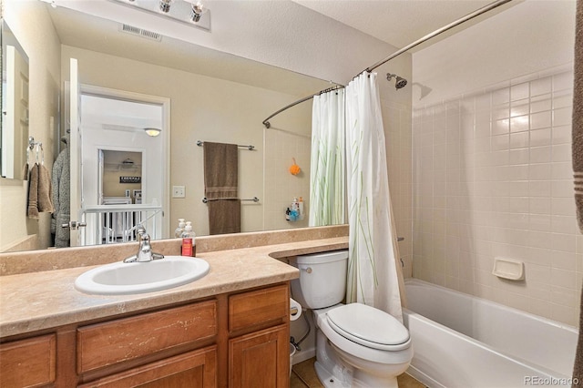 bathroom featuring visible vents, toilet, shower / bath combo, and vanity