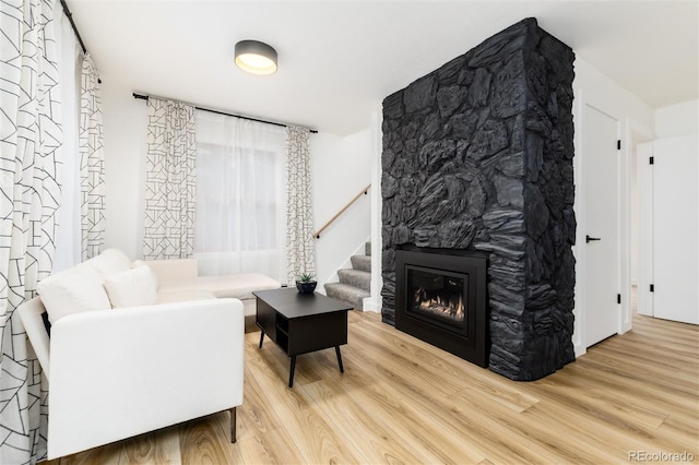 236 Harris Dr, Idaho Springs, CO 80452 - living area featuring wood finished floors, a fireplace, and stairway