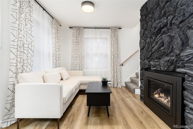 236 Harris Dr, Idaho Springs, CO 80452 - living room with wood finished floors, stairway, and a glass covered fireplace