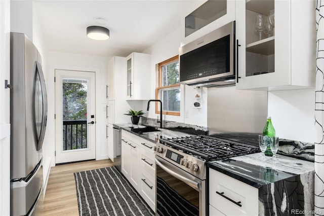 236 Harris Dr, Idaho Springs, CO 80452 - kitchen with appliances with stainless steel finishes, a sink, white cabinetry, and light wood finished floors