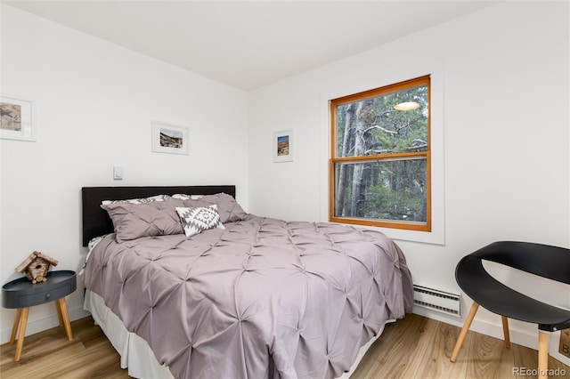 236 Harris Dr, Idaho Springs, CO 80452 - bedroom featuring wood finished floors, a baseboard heating unit, and baseboards