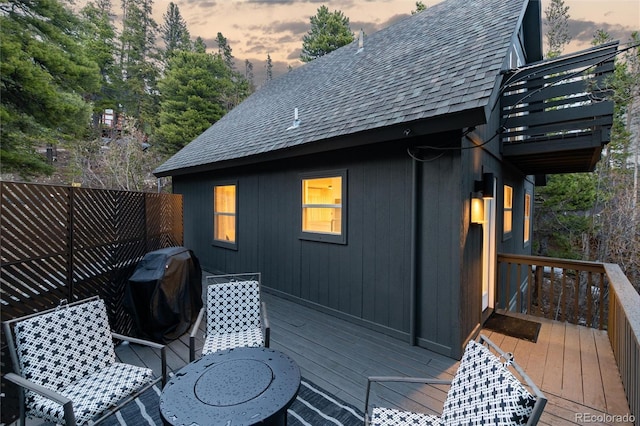 236 Harris Dr, Idaho Springs, CO 80452 - deck at dusk with a grill and view of scattered trees