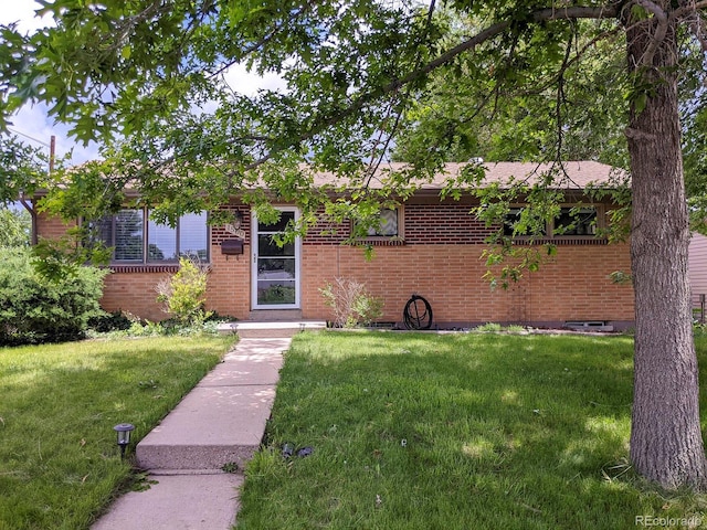 view of front of house featuring a front yard and brick siding
