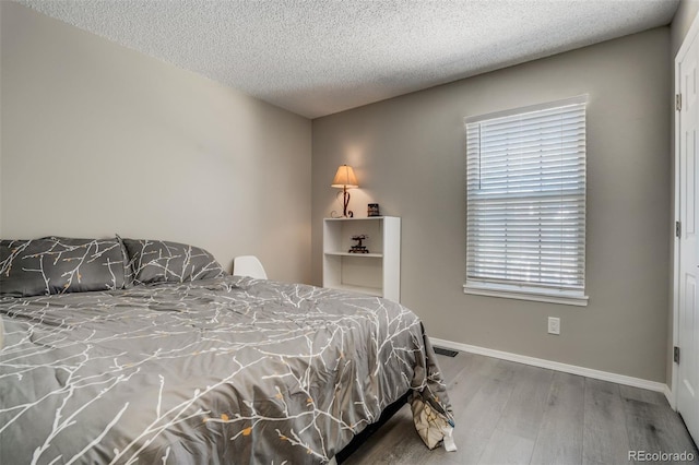 3618 Queen Anne Way, Colorado Springs, CO 80917 - bedroom with baseboards, a textured ceiling, visible vents, and wood finished floors