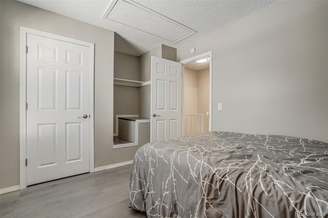 3618 Queen Anne Way, Colorado Springs, CO 80917 - bedroom with baseboards, a textured ceiling, and wood finished floors