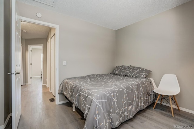 3618 Queen Anne Way, Colorado Springs, CO 80917 - bedroom featuring a textured ceiling, baseboards, visible vents, and wood finished floors