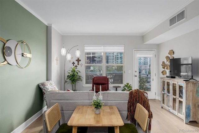 1975 N Grant St Unit 509, Denver, CO 80203 - dining room with wood finished floors, ornamental molding, and baseboards