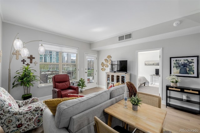 1975 N Grant St Unit 509, Denver, CO 80203 - living room with ornamental molding, light wood-style floors, and baseboards