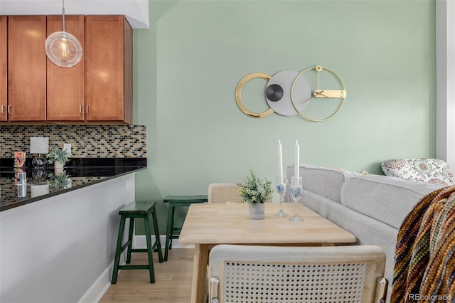 1975 N Grant St Unit 509, Denver, CO 80203 - dining space featuring baseboards and light wood-type flooring